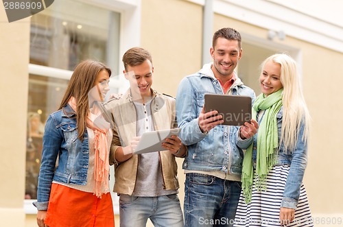 Image of group of smiling friends with tablet pc computers