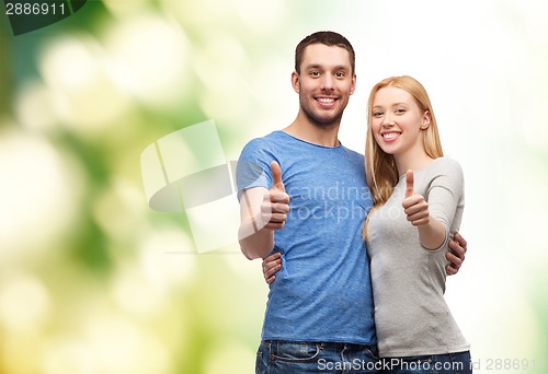 Image of smiling couple showing thumbs up