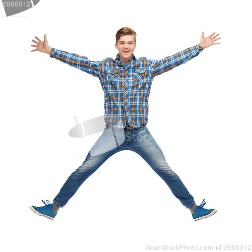 Image of smiling young man jumping in air