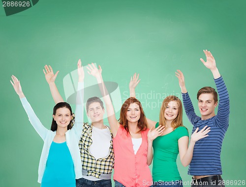 Image of group of smiling students waving hands