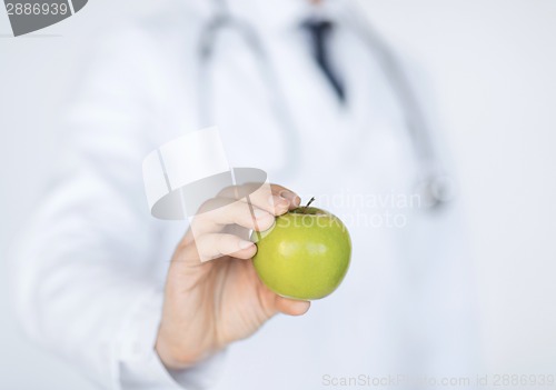 Image of male doctor with green apple