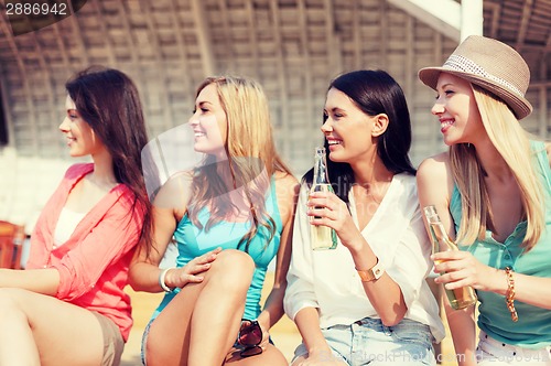 Image of girls with drinks on the beach