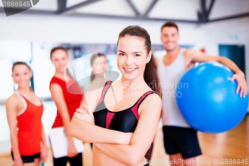 Image of woman standing in front of the group in gym