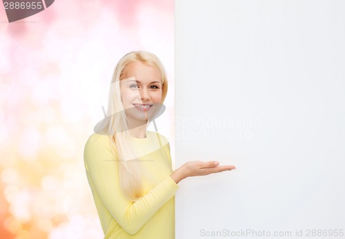 Image of smiling woman in sweater with blank white board