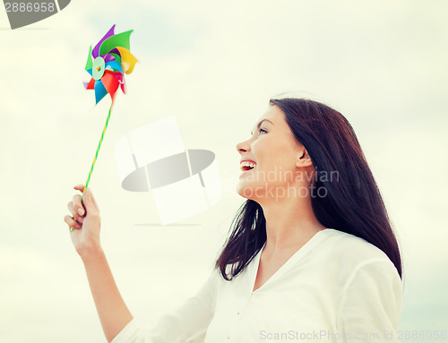 Image of girl with windmill toy on the beach