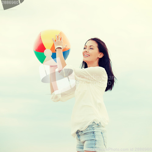 Image of girl with ball on the beach