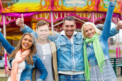 Image of group of smiling friends showing thumbs up