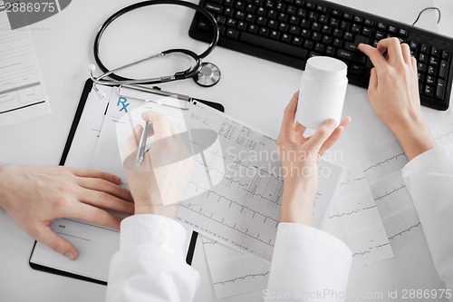 Image of two doctors prescribing medication