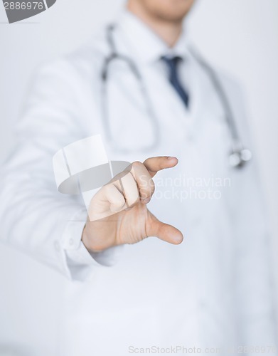 Image of male doctor holding something in his hand