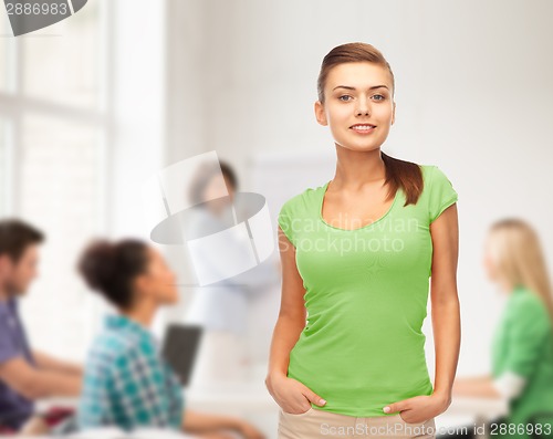 Image of smiling young woman in blank green t-shirt