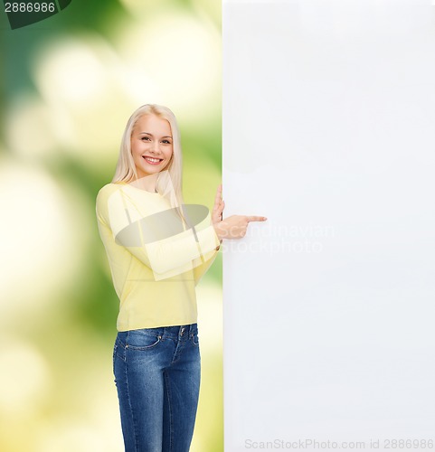 Image of smiling woman in sweater with blank white board