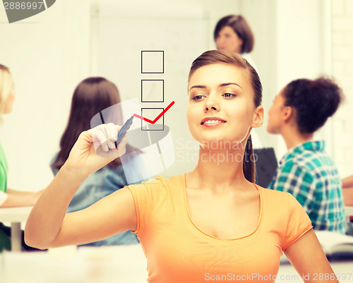 Image of student drawing checkmark on virtual screen