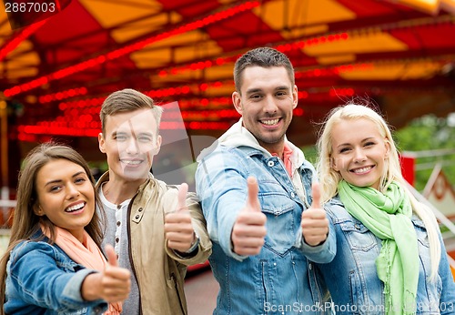 Image of group of smiling friends showing thumbs up