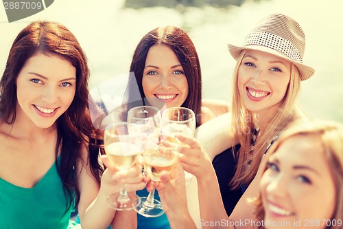 Image of smiling girls with champagne glasses