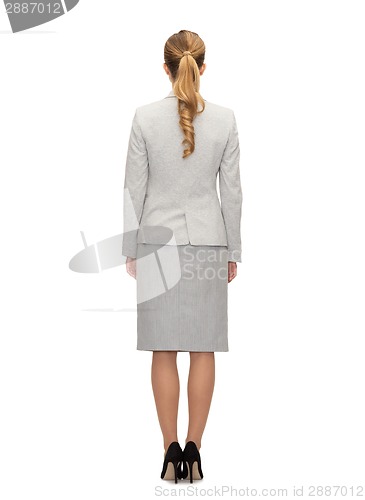 Image of businesswoman or teacher in suit from back