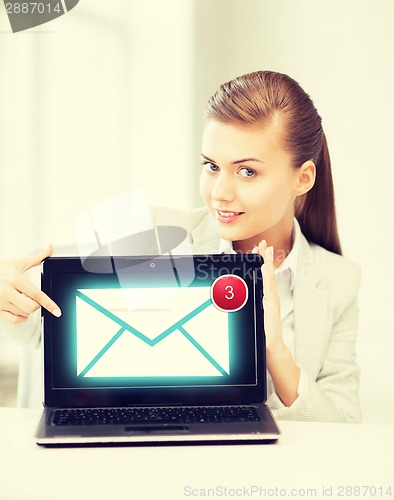 Image of businesswoman with laptop in office