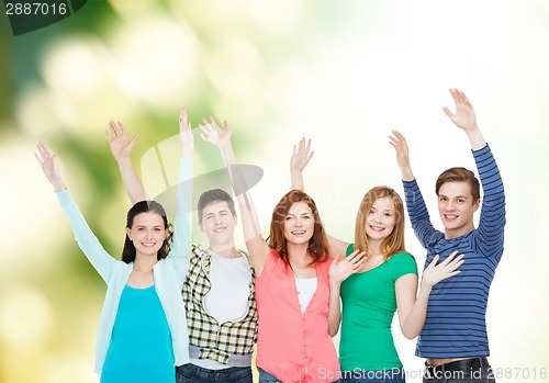 Image of group of smiling students waving hands