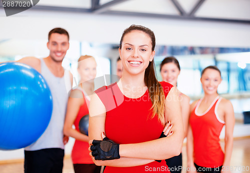 Image of woman standing in front of the group in gym