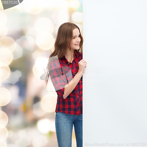 Image of smiling young teenage girl with white blank board