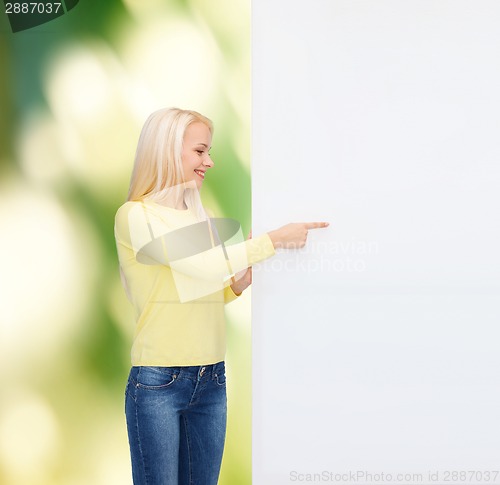 Image of smiling woman in sweater with blank white board