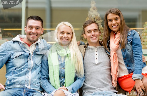 Image of group of smiling friends in city