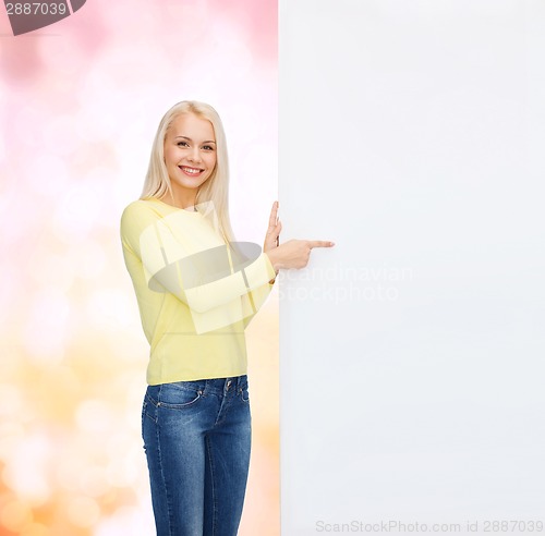 Image of smiling woman in sweater with blank white board