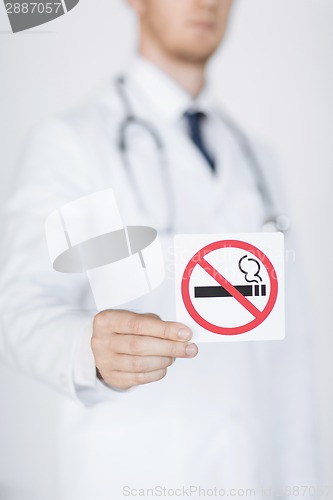 Image of male doctor holding no smoking sign