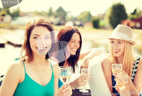 Image of smiling girls with champagne glasses