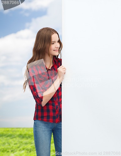 Image of smiling young teenage girl with white blank board