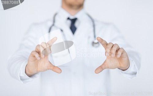 Image of doctor with holding something with hands