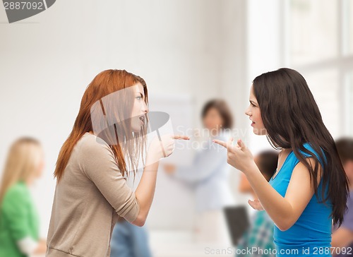 Image of two teenagers having a fight at school