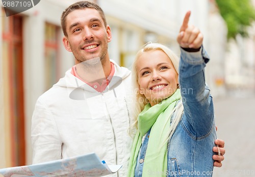 Image of happy couple with map exploring city