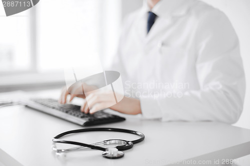 Image of male doctor typing on the keyboard