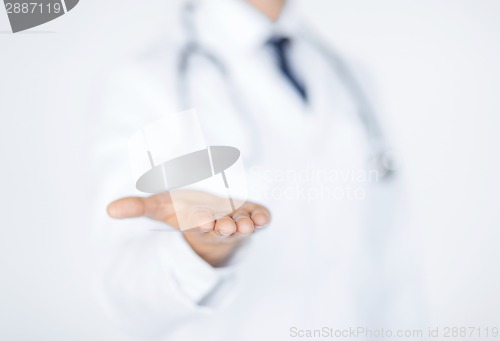 Image of male doctor holding something in his hand