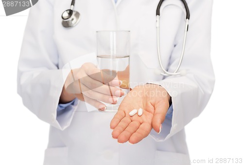 Image of close up of doctor offering pills and water