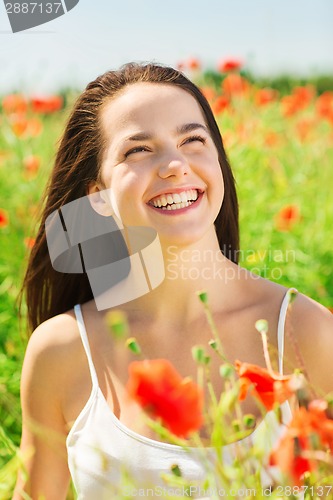 Image of laughing young woman on poppy field