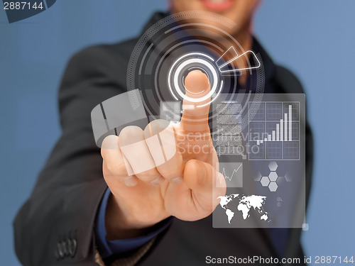 Image of businessman in suit pressing virtual button