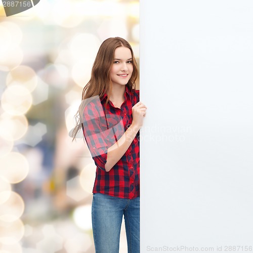 Image of smiling young teenage girl with white blank board