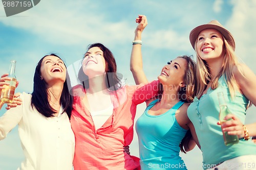 Image of girls with drinks on the beach