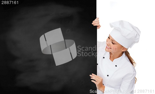 Image of smiling female chef with white blank board