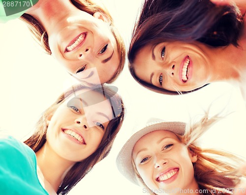 Image of faces of girls looking down and smiling
