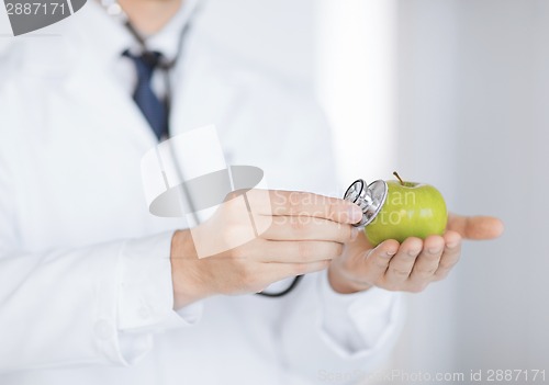 Image of male doctor with green apple and stethoscope
