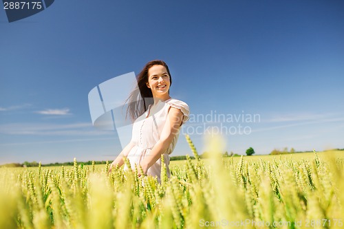 Image of smiling young woman on cereal field