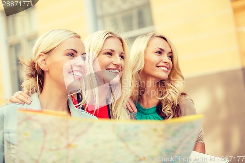 Image of beautiful blonde women with map in the city