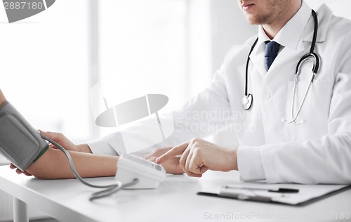 Image of doctor and patient measuring blood pressure