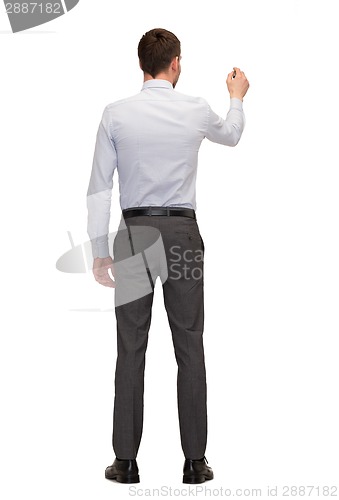 Image of businessman or teacher with marker from back