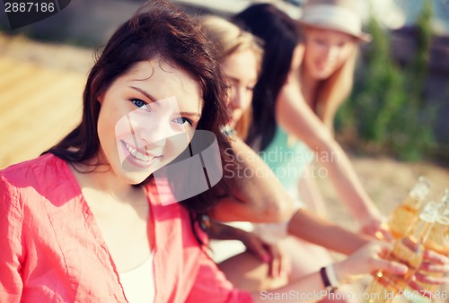 Image of girl with drink on the beach