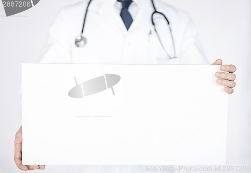 Image of doctor holding blank white banner