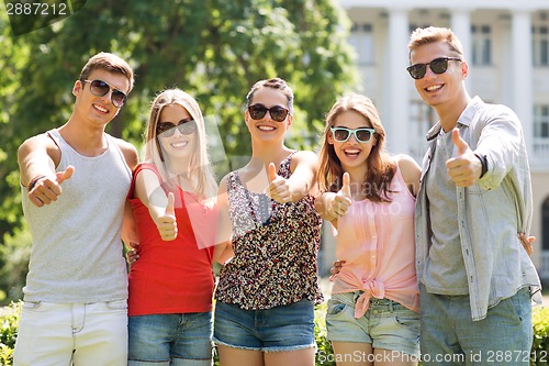 Image of group of smiling friends showing thumbs up