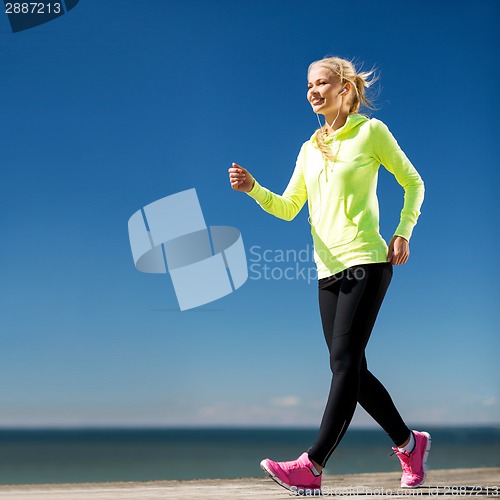 Image of woman walking outdoors